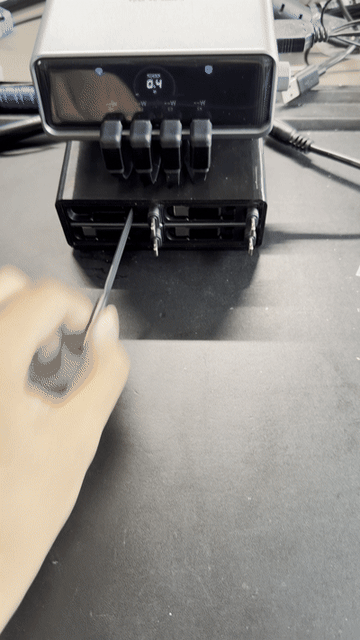Animated demonstration of a cable being pulled from the Anker Prime charging station addon.