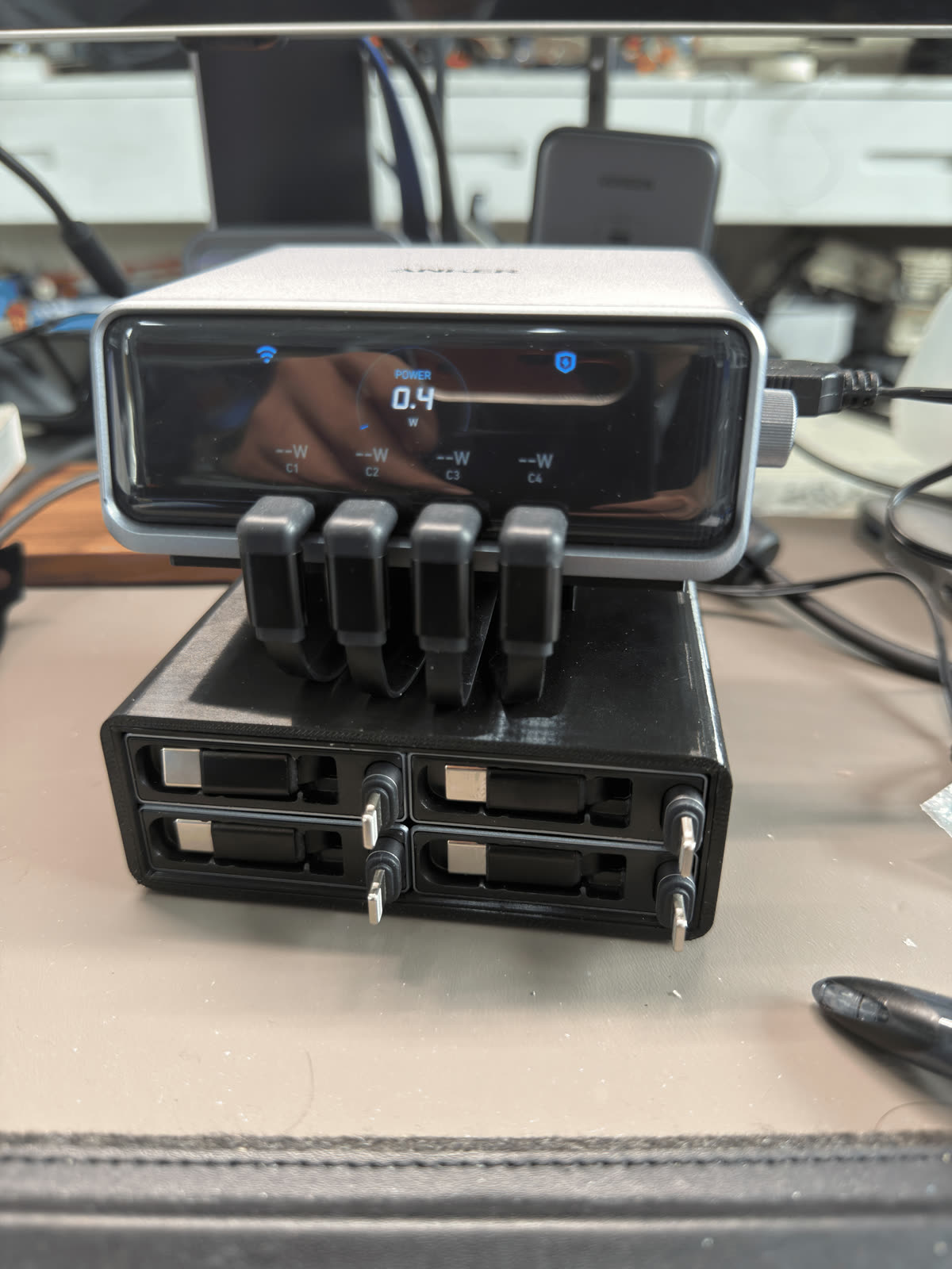 Front view of the Anker Prime 250W charger mounted above the printed cable module base.