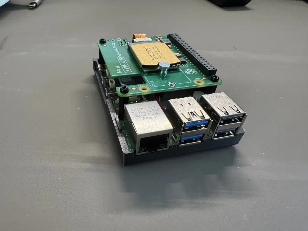 The Raspberry Pi 5 and SSD HAT installed in the lower shell of the case.