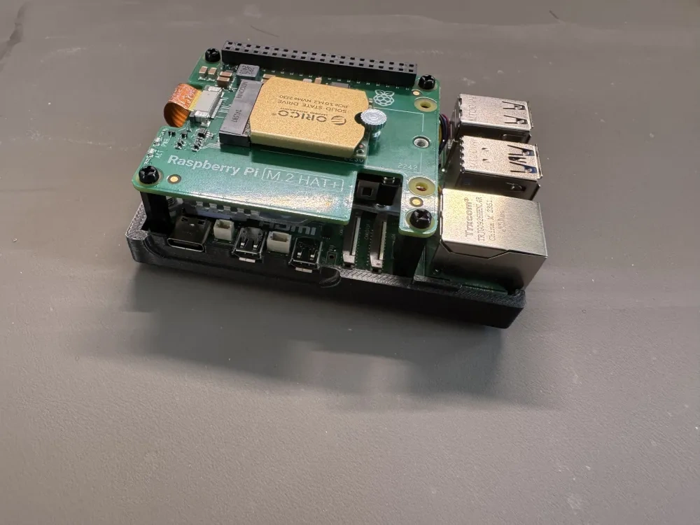 Side view of the Raspberry Pi 5 with SSD HAT mounted inside the lower case shell.