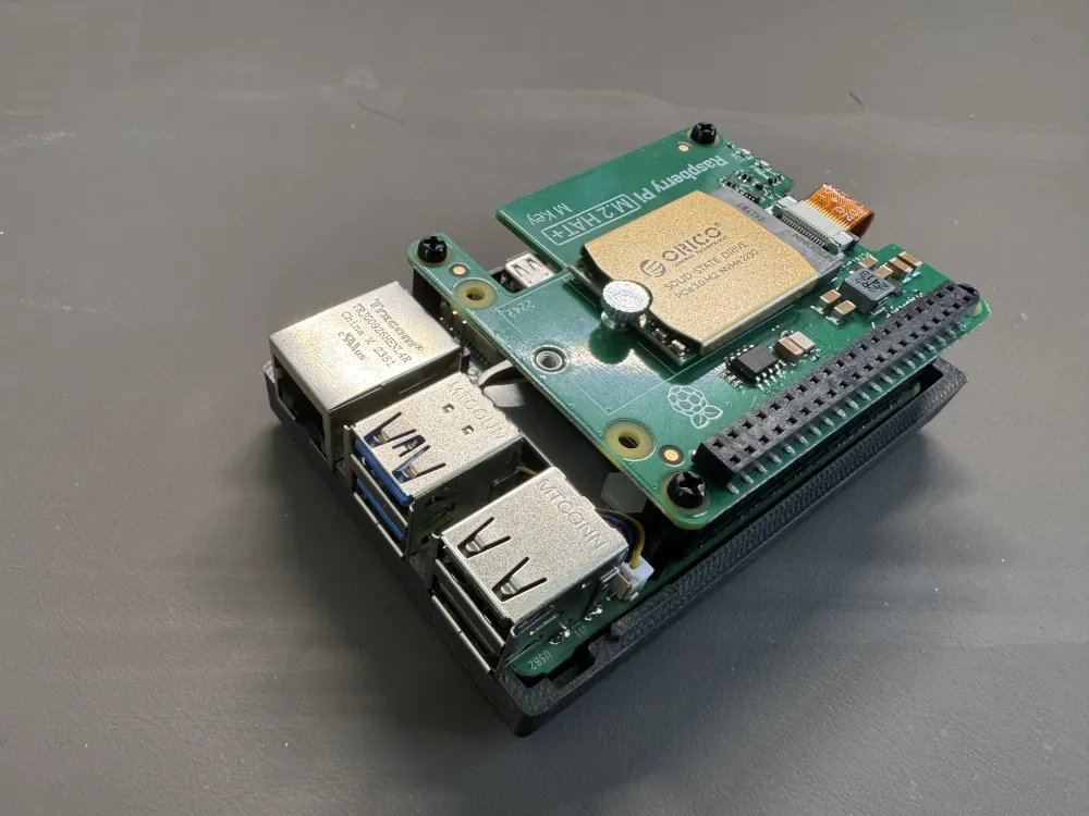 Top view of the Raspberry Pi 5 SSD HAT stack mounted in the printed case.